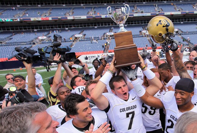 DENVER - SEPTEMBER 04:  Quarterback Cody Hawkins #7 of the Colorado Buffaloes hoists the Centenial Trophy after defeating the Colorado State Rams in the Rocky Mountain Showdown at INVESCO Field at Mile High on September 4, 2010 in Denver, Colorado. Colorado was awarded the Centenial Trophy after they defeated Colorado State 24-3.  (Photo by Doug Pensinger/Getty Images)