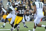 IOWA CITY, IA - OCTOBER 30:  Running back Adam Robinson #32 of the University of Iowa Hawkeyes rushes for yards past safety Marcu Hyde #11 of the Michigan State Spartans during the second half of play at Kinnick Stadium on October 30, 2010 in Iowa City, Iowa. Iowa won 37-6 over Michigan State. (Photo by David Purdy/Getty Images)