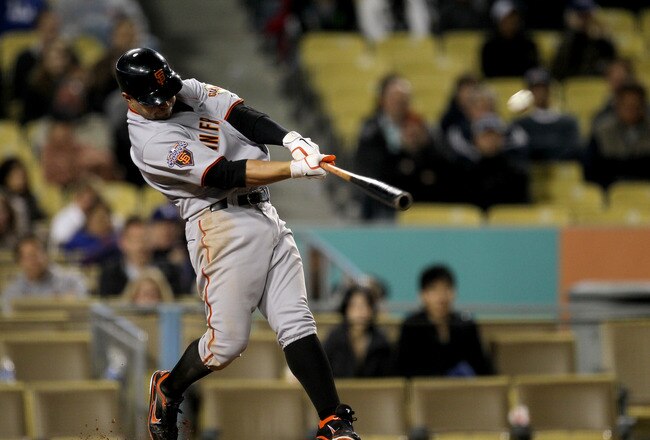 LOS ANGELES - MAY 18: Cody Ross #13 of the San Francisco Giants hits a three run home run in the ninth inning against the Los Angeles Dodgers on May 18, 2011 at Dodger Stadium in Los Angeles, California.  (Photo by Stephen Dunn/Getty Images)