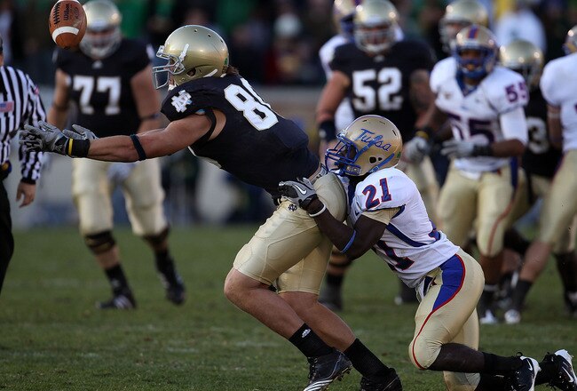 SOUTH BEND, IN - OCTOBER 30: Tyler Eifert #80 of the Notre Dame Fighting Irish drops a pass as he is hit by John Flanders #21 of the Tulsa Golden Hurricane at Notre Dame Stadium on October 30, 2010 in South Bend, Indiana. Tulsa defeated Notre Dame 28-27. (Photo by Jonathan Daniel/Getty Images)