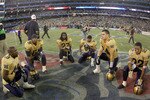 TORONTO, ON - NOVEMBER 25:  Memebers of the Winnipeg Blue Bombers team kneel at midfield after a their loss to the Saskatchewan Rough Riders during the 95th Grey Cup on November 25, 2007 at the Rogers Centre in Toronto, Ontario, Canada.  (Photo by Harry How/Getty Images)