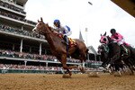 LOUISVILLE, KY - MAY 07: (L-R) Jockeys Jesus L. Castanon (C), riding Shackleford #14 and Patrick Valenzuela, riding Comma to the Top #6, lead the field down the front stretch at the start of the 137th Kentucky Derby at Churchill Downs on May 7, 2011 in Louisville, Kentucky. (Photo by Rob Carr/Getty Images)