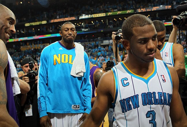 NEW ORLEANS, LA - APRIL 28:  Chris Paul #3 of the New Orleans Hornets walks off the court after a 98-80 loss as Kobe Bryant #24 of the Los Angeles Lakers smiles after winning the series in Game Six of the Western Conference Quarterfinals in the 2011 NBA Playoffs on April 28, 2011 at New Orleans Arena in New Orleans, Louisiana.  NOTE TO USER: User expressly acknowledges and agrees that, by downloading and or using this photograph, User is consenting to the terms and conditions of the Getty Images License Agreement.  (Photo by Ronald Martinez/Getty Images)