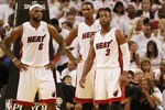 MIAMI, FL - APRIL 16:  Forward Chris Bosh #1 of the  Miami Heat with teammates Dwyane Wade #3 and LeBron James #6 against the Philadelphia 76ers at the American Airlines Arena in game one of the Eastern Conference Quarterfinals in the 2011 NBA Playoffs on April 16, 2011 in Miami, Florida. NOTE TO USER: User expressly acknowledges and agrees that, by downloading and or using this photograph, User is consenting to the terms and conditions of the Getty Images Liscence agreement.  (Photo by Marc Serota/Getty Images)