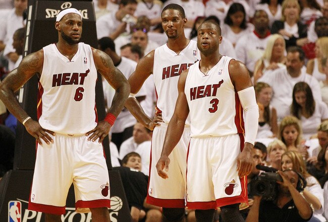 MIAMI, FL - APRIL 16:  Forward Chris Bosh #1 of the  Miami Heat with teammates Dwyane Wade #3 and LeBron James #6 against the Philadelphia 76ers at the American Airlines Arena in game one of the Eastern Conference Quarterfinals in the 2011 NBA Playoffs on April 16, 2011 in Miami, Florida. NOTE TO USER: User expressly acknowledges and agrees that, by downloading and or using this photograph, User is consenting to the terms and conditions of the Getty Images Liscence agreement.  (Photo by Marc Serota/Getty Images)