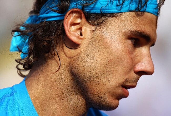 PARIS, FRANCE - MAY 24:  Rafael Nadal of Spain looks on during the men's singles round one match between Rafael Nadal of Spain and John Isner of USA on day three of the French Open at Roland Garros on May 24, 2011 in Paris, France.  (Photo by Clive Brunskill/Getty Images)