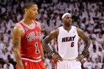MIAMI, FL - MAY 22:  LeBron James (R) #6 of the Miami Heat looks on as Derrick Rose #1 of the Chicago Bulls stands in the foregrouns in Game Three of the Eastern Conference Finals during the 2011 NBA Playoffs on May 22, 2011 at American Airlines Arena in Miami, Florida.  NOTE TO USER: User expressly acknowledges and agrees that, by downloading and or using this photograph, User is consenting to the terms and conditions of the Getty Images License Agreement.  (Photo by Mike Ehrmann/Getty Images)