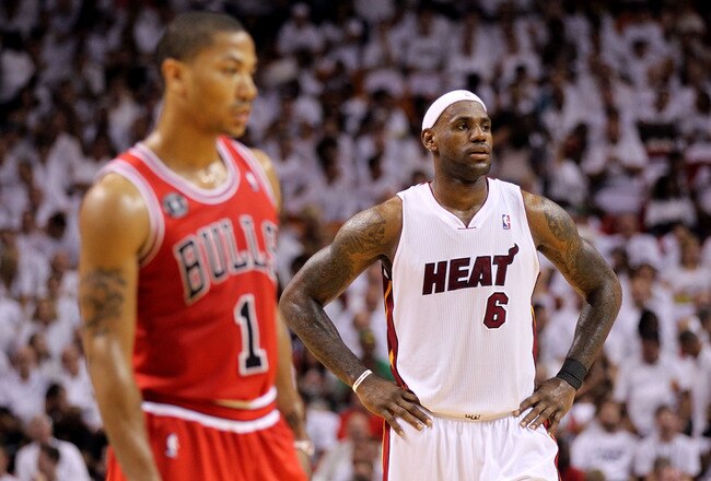 MIAMI, FL - MAY 22:  LeBron James (R) #6 of the Miami Heat looks on as Derrick Rose #1 of the Chicago Bulls stands in the foregrouns in Game Three of the Eastern Conference Finals during the 2011 NBA Playoffs on May 22, 2011 at American Airlines Arena in Miami, Florida.  NOTE TO USER: User expressly acknowledges and agrees that, by downloading and or using this photograph, User is consenting to the terms and conditions of the Getty Images License Agreement.  (Photo by Mike Ehrmann/Getty Images)