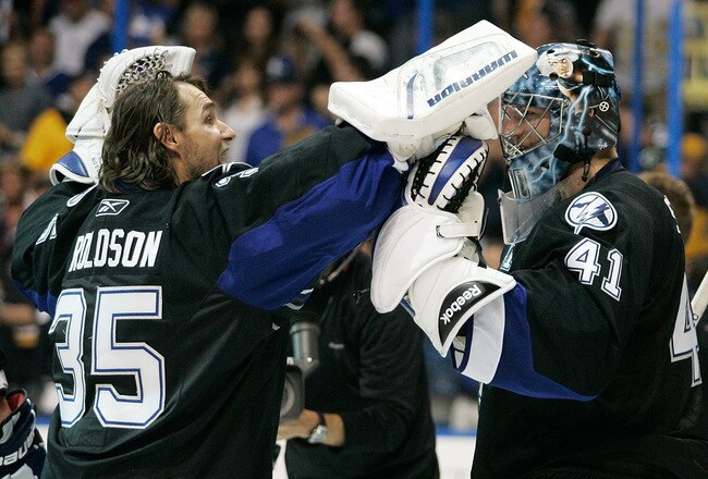TAMPA, FL - MAY 21:  Dwayne Roloson #35 celebrates with Mike Smith #41 of the Tampa Bay Lightning after they defeated the Boston Bruins 5 to 3 in Game Four of the Eastern Conference Finals during the 2011 NHL Stanley Cup Playoffs at St Pete Times Forum on May 21, 2011 in Tampa, Florida.  (Photo by Justin K. Aller/Getty Images)