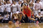 MIAMI, FL - MAY 24:  LeBron James #6 of the Miami Heat reaches for a loose ball against Joakim Noah #13 of the Chicago Bulls in Game Four of the Eastern Conference Finals during the 2011 NBA Playoffs on May 24, 2011 at American Airlines Arena in Miami, Florida. The Heat won 101-93 in overtime. NOTE TO USER: User expressly acknowledges and agrees that, by downloading and or using this photograph, User is consenting to the terms and conditions of the Getty Images License Agreement.  (Photo by Mike Ehrmann/Getty Images)
