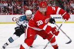 DETROIT - MAY 6: Brian Rafalski #28 of the Detroit Red Wings controls the puck in front of Torrey Mitchell #17 of the San Jose Sharks during the third period in Game Four of the Western Conference Semifinals during the 2011 NHL Stanley Cup Playoffs on May 6, 2011 at Joe Louis Arena in Detroit, Michigan. Detroit won the game 4-3. San Jose leads the series 3-1. (Photo by Gregory Shamus/Getty Images)