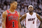 MIAMI, FL - MAY 22:  Derrick Rose #1 of the Chicago Bulls looks on as LeBron James #6 of the Miami Heat stands in the background in Game Three of the Eastern Conference Finals during the 2011 NBA Playoffs on May 22, 2011 at American Airlines Arena in Miami, Florida.  NOTE TO USER: User expressly acknowledges and agrees that, by downloading and or using this photograph, User is consenting to the terms and conditions of the Getty Images License Agreement.  (Photo by Mike Ehrmann/Getty Images)