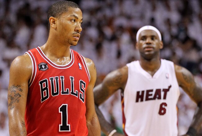 MIAMI, FL - MAY 22:  Derrick Rose #1 of the Chicago Bulls looks on as LeBron James #6 of the Miami Heat stands in the background in Game Three of the Eastern Conference Finals during the 2011 NBA Playoffs on May 22, 2011 at American Airlines Arena in Miami, Florida.  NOTE TO USER: User expressly acknowledges and agrees that, by downloading and or using this photograph, User is consenting to the terms and conditions of the Getty Images License Agreement.  (Photo by Mike Ehrmann/Getty Images)