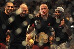LAS VEGAS - JULY 11:  (2nd R) Georges St. Pierre celebrates his victory against Thiago Alves during their welterweight title bout during UFC 100 on July 11, 2009 in Las Vegas, Nevada. St. Pierre defeated Alves by unanimous decision.  (Photo by Jon Kopaloff/Getty Images)
