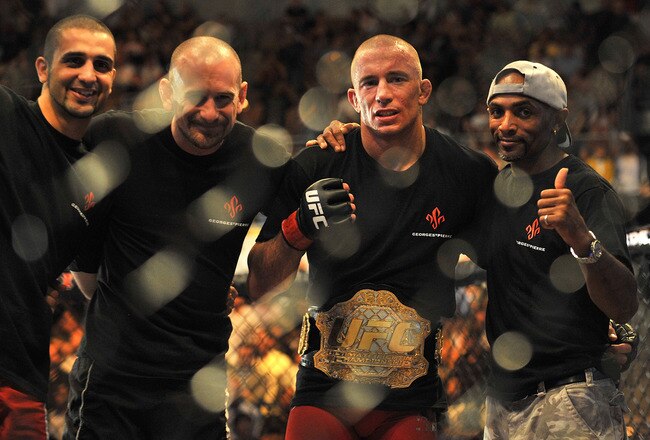 LAS VEGAS - JULY 11:  (2nd R) Georges St. Pierre celebrates his victory against Thiago Alves during their welterweight title bout during UFC 100 on July 11, 2009 in Las Vegas, Nevada. St. Pierre defeated Alves by unanimous decision.  (Photo by Jon Kopaloff/Getty Images)