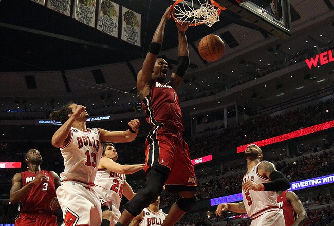 CHICAGO, IL - MAY 26: Chris Bosh #1 of the Miami Heat dunks against Joakim Noah #13 and Carlos Boozer #5 of the Chicago Bulls in Game Five of the Eastern Conference Finals during the 2011 NBA Playoffs on May 26, 2011 at the United Center in Chicago, Illinois. NOTE TO USER: User expressly acknowledges and agrees that, by downloading and or using this photograph, User is consenting to the terms and conditions of the Getty Images License Agreement.  (Photo by Jonathan Daniel/Getty Images)