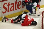 CHICAGO, IL - APRIL 17: Chris Campoli #14 of the Chicago Blackhawks hits Raffi Torres #13 of the Vancouver Canucks after Torres knocked down Brent Seabrook #7 with a hit behind the net in Game Three of the Western Conference Quarterfinals during the 2011 NHL Stanley Cup Playoffs at the United Center on April 17, 2011 in Chicago, Illinois. (Photo by Jonathan Daniel/Getty Images)