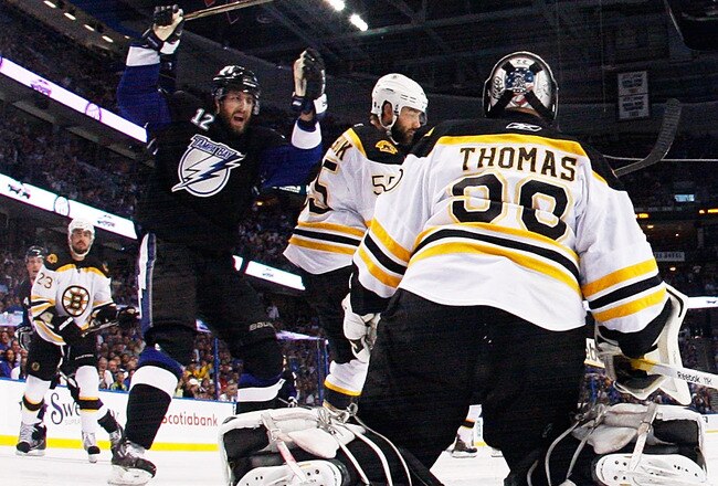 TAMPA, FL - MAY 25:  Simon Gagne #12 of the Tampa Bay Lightning celebrates a goal by Teddy Purcell #16 as Tim Thomas #30 of the Boston Bruins defends in Game Six of the Eastern Conference Finals during the 2011 NHL Stanley Cup Playoffs at St Pete Times Forum on May 25, 2011 in Tampa, Florida.  (Photo by Justin K. Aller/Getty Images)