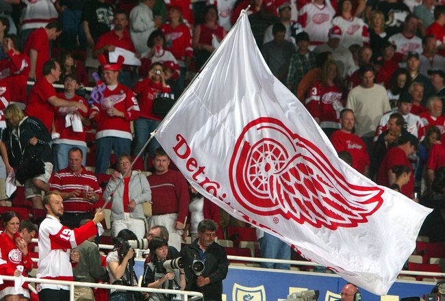 DETROIT - MAY 26:  A fan of the Detroit Red Wings waves a Red Wing flag during game two of the 2008 NHL Stanley Cup Finals against the Pittsburgh Penguins at Joe Louis Arena on May 26, 2008 in Detroit, Michigan. The Red Wings defeated the Penguins 3-0 to set the series at 2-0 Red Wings. (Photo by Jim McIsaac/Getty Images)