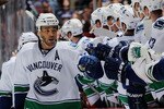 ANAHEIM, CA - OCTOBER 13:  Manny Malhotra #27 of the Vancouver Canucks celebrates with teammates during their game against the Anaheim Ducks at Honda Center on October 13, 2010 in Anaheim, California.  (Photo by Jeff Gross/Getty Images)