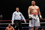 LAS VEGAS - APRIL 11:  Chris Arreola  (R) walks away from referee Tony Weeks (C) and Jameel McCline after knocking him out in the fourth round of their heavyweight bout at the Mandalay Bay Events Center April 11, 2009 in Las Vegas, Nevada.  (Photo by Ethan Miller/Getty Images)