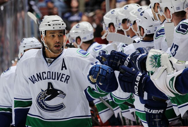ANAHEIM, CA - OCTOBER 13:  Manny Malhotra #27 of the Vancouver Canucks celebrates with teammates during their game against the Anaheim Ducks at Honda Center on October 13, 2010 in Anaheim, California.  (Photo by Jeff Gross/Getty Images)