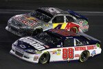 CONCORD, NC - MAY 29:  Dale Earnhardt Jr., driver of the #88 National Guard/Amp Energy Chevrolet, races side by side with Kasey Kahne, driver of the #4 Red Bull Toyota, during the NASCAR Sprint Cup Series Coca-Cola 600 at Charlotte Motor Speedway on May 29, 2011 in Concord, North Carolina.  (Photo by Jerry Markland/Getty Images for NASCAR)