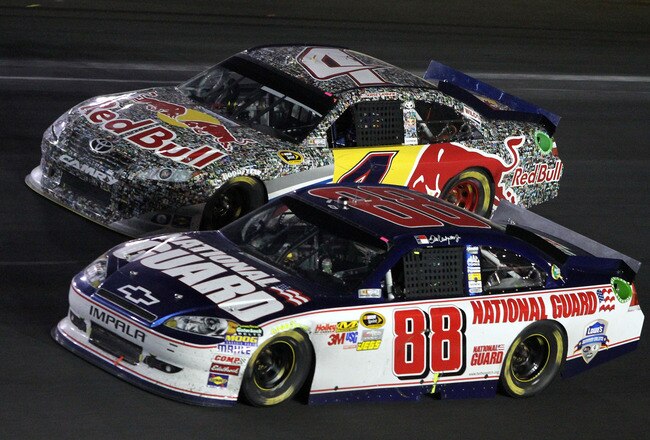 CONCORD, NC - MAY 29:  Dale Earnhardt Jr., driver of the #88 National Guard/Amp Energy Chevrolet, races side by side with Kasey Kahne, driver of the #4 Red Bull Toyota, during the NASCAR Sprint Cup Series Coca-Cola 600 at Charlotte Motor Speedway on May 29, 2011 in Concord, North Carolina.  (Photo by Jerry Markland/Getty Images for NASCAR)