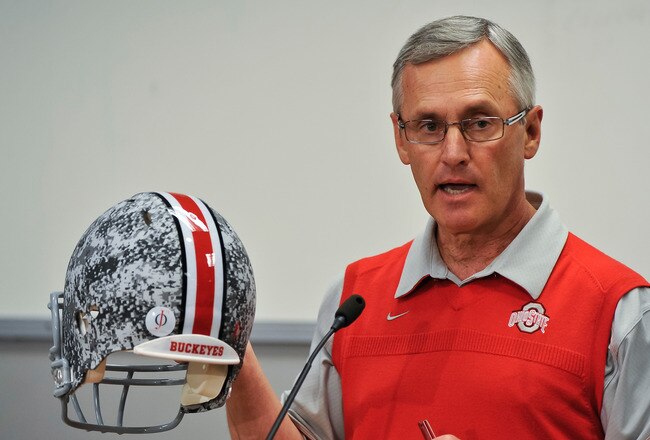 COLUMBUS, OH - MARCH 30:  Head Coach Jim Tressel shows off a football helmet with military camouflage to the media during a press conference before the start of Spring practices at the Woody Hayes Athletic Center at The Ohio State University on March 30, 2011 in Columbus, Ohio. The Buckeyes will wear the helmets just during spring practice to honor the U.S. military.  (Photo by Jamie Sabau/Getty Images)