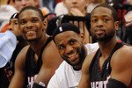 MINNEAPOLIS, MN - APRIL 1: Chris Bosh #1, LeBron James #6 and Dwyane Wade #3 of the Miami Heat sit on the bench in the final minutes of a basketball game against the Minnesota Timberwolves at Target Center on April 1, 2011 in Minneapolis, Minnesota. Heat defeated the Timberwolves 111- 92. NOTE TO USER: User expressly acknowledges and agrees that, by downloading and or using this Photograph, user is consenting to the terms and conditions of the Getty Images License Agreement.  (Photo by Hannah Foslien /Getty Images)