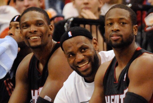 MINNEAPOLIS, MN - APRIL 1: Chris Bosh #1, LeBron James #6 and Dwyane Wade #3 of the Miami Heat sit on the bench in the final minutes of a basketball game against the Minnesota Timberwolves at Target Center on April 1, 2011 in Minneapolis, Minnesota. Heat defeated the Timberwolves 111- 92. NOTE TO USER: User expressly acknowledges and agrees that, by downloading and or using this Photograph, user is consenting to the terms and conditions of the Getty Images License Agreement.  (Photo by Hannah Foslien /Getty Images)