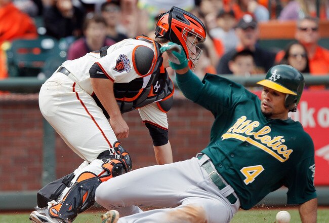 SAN FRANCISCO, CA - MAY 22:  Coco Crisp #4 of the Oakland A's scores a go-ahead run from second base ahead of the throw to catcher Buster Posey #28 of the San Francisco Giants on a single by Daric Barton in the seventh inning at AT&T Park on May 22, 2011 in San Francisco, California.  The A's lead 3-2.  (Photo by Brian Bahr/Getty Images)