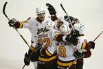 ROSEMONT, IL - JUNE 10:  Darren Haydar #20 (L) and Joel Kwiatkowski #8 of the Chicago Wolves celebrate with Nathan Oystrick #22 and other teammates after Oystrick scored a power-play goal against the Wilkes-Barre/Scranton Penguins during the Calder Cup Finals on June 10, 2008 at the Allstate Arena in Rosemont, Illinois.  (Photo by Jonathan Daniel/Getty Images)