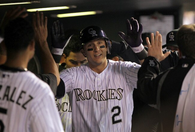 DENVER, CO - APRIL 05:  Troy Tulowitzki #2 of the Colorado Rockies is congratulated in the dugout after his solo homerun off of starting pitcher Clayton Kershaw of the Los Angeles Dodgers to give the Rockies a 1-0 lead in the fourth inning at Coors Field on April 5, 2011 in Denver, Colorado.  (Photo by Doug Pensinger/Getty Images)