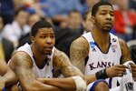 SAN ANTONIO, TX - MARCH 27: Marcus Morris #22 and Markieff Morris #21 of the Kansas Jayhawks react during the southwest regional final of the 2011 NCAA men's basketball tournament at the Alamodome on March 27, 2011 in San Antonio, Texas. Virginia Commonwealth defeated Kansas 71-61. (Photo by Ronald Martinez/Getty Images)