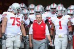 LOS ANGELES, CA - SEPTEMBER 13:  Head coach Jim Tressel of the Ohio State Buckeyes leads teammates Alex Boone #75 and Marcus Freeman #1 out onto the field before the college football game against the USC Trojans at Los Angeles Memorial Coliseum on September 13, 2008 in Los Angeles, California. The Trojans defeated the Buckeyes 35-3.  (Photo by Christian Petersen/Getty Images)