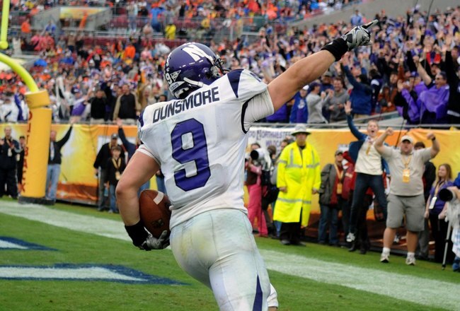 TAMPA, FL - JANUARY 1: Split back Drake Dunsmore #9 of the Northwestern Wildcats celebrates a touchdown against the Auburn Tigers in the Outback Bowl January 1, 2010 at Raymond James Stadium in Tampa, Florida.  (Photo by Al Messerschmidt/Getty Images)