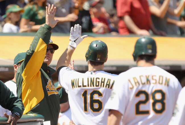 OAKLAND, CA - MAY 29:  Josh Willingham #16 of the Oakland Athletics is congratulated by manager Bob Geren after he hit a three-run home run against the Baltimore Orioles at Oakland-Alameda County Coliseum on May 29, 2011 in Oakland, California.  (Photo by Ezra Shaw/Getty Images)