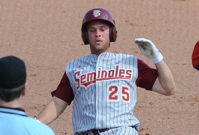 CLEARWATER, FL - FEBRUARY 24:  Outfielder Mike McGee #25 of  the Florida State Seminoles slides into third base against the Philadelphia Phillies February 24, 2011 at Bright House Field in Clearwater, Florida.  (Photo by Al Messerschmidt/Getty Images)