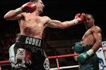 NOTTINGHAM, ENGLAND - OCTOBER 17:  Carl Froch (L) connects with a left hook as he retains his title against Andre Dirrell during their WBC Super Middleweight fight on October 17, 2009 at Trent FM Arena in Nottingham, England.  (Photo by John Gichigi/Getty Images)