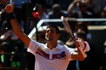 PARIS, FRANCE - MAY 28:  Novak Djokovic of Serbia
salutes the crowd as he celebrates match point during the men's singles round three match between Juan Martin Del Potro of Argentina and Novak Djokovic of Serbia on day seven of the French Open at Roland Garros on May 28, 2011 in Paris, France.  (Photo by Alex Livesey/Getty Images)