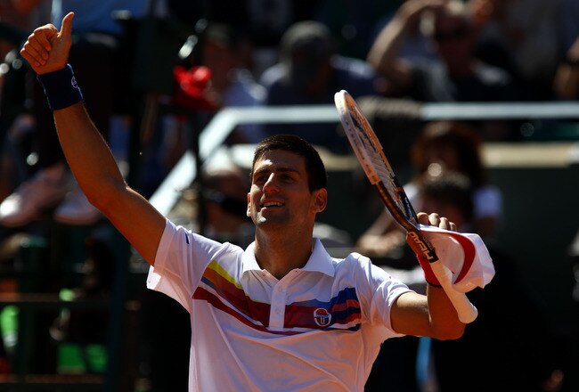 PARIS, FRANCE - MAY 28:  Novak Djokovic of Serbia
salutes the crowd as he celebrates match point during the men's singles round three match between Juan Martin Del Potro of Argentina and Novak Djokovic of Serbia on day seven of the French Open at Roland Garros on May 28, 2011 in Paris, France.  (Photo by Alex Livesey/Getty Images)
