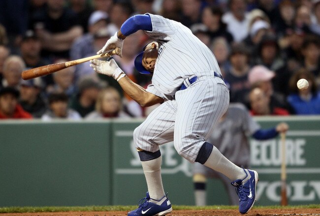 BOSTON, MA - MAY 21:  Marlon Byrd #24 of the Chicago Cubs is hits a in the head by a pitch in the second inning against the Boston Red Sox  on May 21, 2011 at Fenway Park in Boston, Massachusetts. Tonight the Chicago Cubs and the Boston Red Sox are wearing replica uniforms from 1918. Before this series, the two teams haven't played at Fenway Park since the 1918 World Series.  (Photo by Elsa/Getty Images)