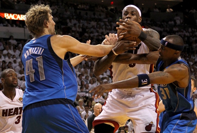 MIAMI, FL - JUNE 02:  LeBron James #6 of the Miami Heat drives between Dirk Nowitzki #41 and Jason Terry #31 of the Dallas Mavericks in the fourth quarter in Game Two of the 2011 NBA Finals at American Airlines Arena on June 2, 2011 in Miami, Florida. NOTE TO USER: User expressly acknowledges and agrees that, by downloading and/or using this Photograph, user is consenting to the terms and conditions of the Getty Images License Agreement.  (Photo by Ronald Martinez/Getty Images)