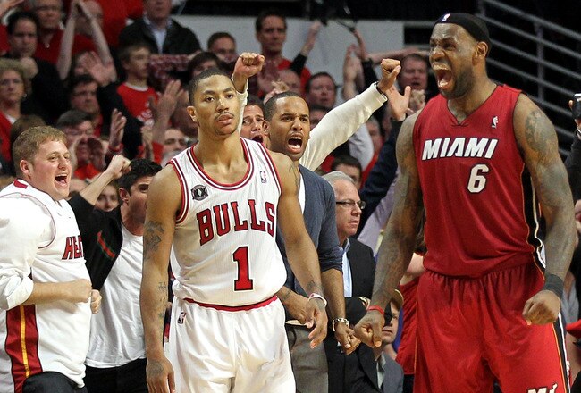 CHICAGO, IL - MAY 26:  Derrick Rose #1 of the Chicago Bulls looks on dejected as LeBron James #6 of the Miami Heat celebrates after the Heat won 83-80 in Game Five of the Eastern Conference Finals during the 2011 NBA Playoffs on May 26, 2011 at the United Center in Chicago, Illinois. NOTE TO USER: User expressly acknowledges and agrees that, by downloading and or using this photograph, User is consenting to the terms and conditions of the Getty Images License Agreement.  (Photo by Mike Ehrmann/Getty Images)