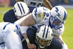 PROVO, UT - OCTOBER 29:  John Rabold #32 and Brad Meissen #36 of Air Force tackle Michael Reed (C) of Brigham Young University during the second quarter October 29, 2005 at LaVell Edwards Stadium in Provo, Utah.  (Photo by George Frey/Getty Images)