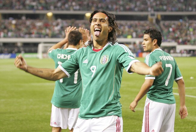 ARLINGTON, TX - JUNE 05:  Aldo De Nigris # 9 flanked Javier Hernandez #14 and Pablo Barrera #7 of Mexico celebrates a goal scored against El Salvador during the CONCACAF Gold Cup qualifying match at Cowboys Stadium on June 5, 2011 in Arlington, Texas.  (Photo by Rick Yeatts/Getty Images)