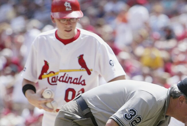 ST. LOUIS - JUNE 30: Home plate umpire Kerwin Danley is tended to by fellow umpire Dana Demuth after Danley fell down in the bottom of the fifth inning due to heat exhaustion. The Cincinnati Reds beat the St. Louis Cardinals 12-8 at Busch Stadium in St. Louis, Missouri on June 30, 2002.  (Photo by Elsa/Getty Images)