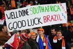 JOHANNESBURG, SOUTH AFRICA - JULY 11:  Netherlands fans enjoy the atmosphere prior to the 2010 FIFA World Cup South Africa Final match between Netherlands and Spain at Soccer City Stadium on July 11, 2010 in Johannesburg, South Africa.  (Photo by Clive Mason/Getty Images)