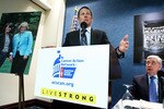 WASHINGTON, DC - MARCH 24:  LIVESTRONG Founder and Chairman and seven-time Tour de France champion Lance Armstrong (L) speaks as American Cancer Society Cancer Action Network Chief Executive John Seffrin (R) listens during a news conference at the National Press Club March 24, 2011 in Washington, DC. American Cancer Society Cancer Action Network held a news conference to call on the Congress to oppose proposed cuts to cancer research and prevention programs.  (Photo by Alex Wong/Getty Images)